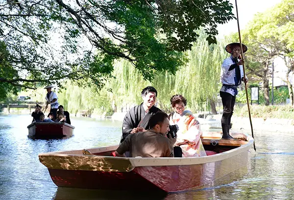 전통 의상을 입고 노를 저으며 노래하는 베테랑 뱃사공의 모습