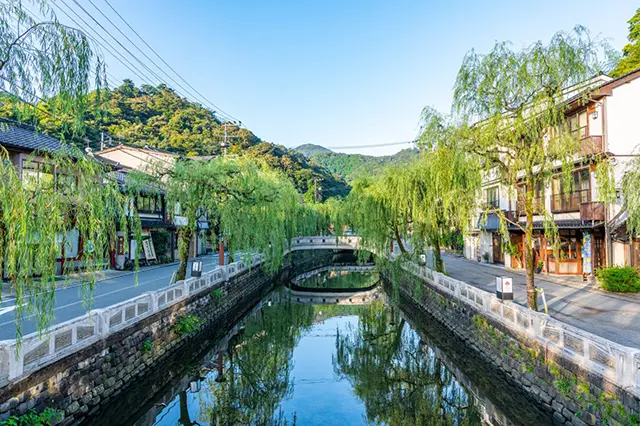 Traditional Kinosaki Onsen town street with willow trees